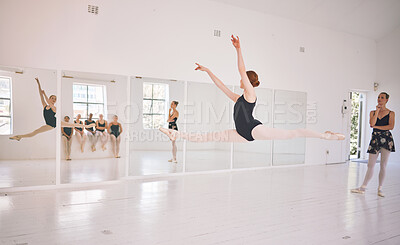 Buy stock photo Young woman dance instructor teaching a ballet class to a group of a children in her studio. Ballerina teacher working with girl students, preparing for their recital, performance or upcoming show