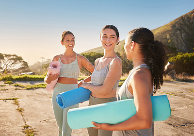 Buy stock photo Beautiful yoga women bonding and holding yoga mats in outdoor practice in remote nature. Diverse group of young smiling active friends standing together. Three happy people getting ready to be mindful