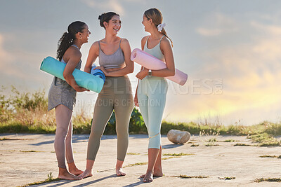 Buy stock photo Full length yoga women bonding, holding yoga mats in outdoor practice in remote nature. Diverse group of young smiling active friends standing together. Three happy people getting ready to be mindful