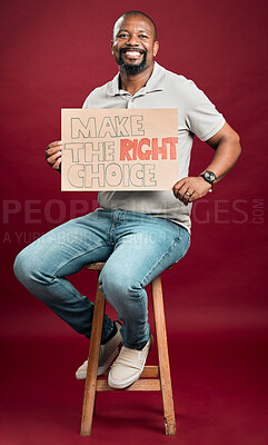 Buy stock photo African american covid vaccinated man showing and holding poster. Smiling black man isolated against red studio background with copyspace. Happy model using sign to promote corona vaccine and motivate