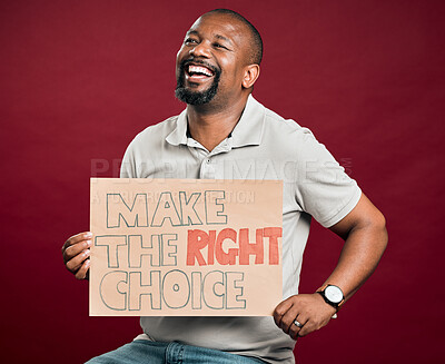 Buy stock photo African american covid vaccinated man showing and holding poster. Smiling black man isolated against red studio background with copyspace. Happy model using sign to promote corona vaccine and motivate