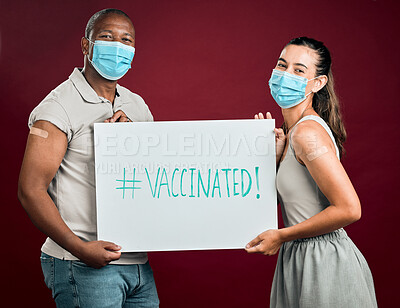 Buy stock photo Covid vaccinated African american man and mixed race woman showing and holding poster. Two people wearing surgical face mask isolated on red studio background with copyspace. Promote corona vaccine