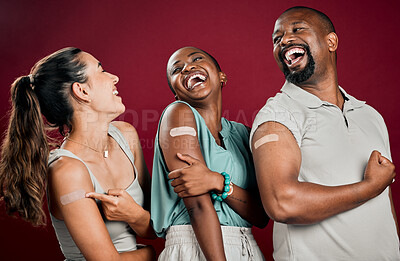Buy stock photo Covid vaccinated diverse group of people showing plaster on arm. African american man and woman with mixed race woman isolated on red studio background with copyspace. Promote health in corona vaccine