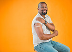African american covid vaccinated man showing plaster on arm and smiling. Portrait of black man isolated against yellow studio background with copyspace. Protected from corona with vaccine injection