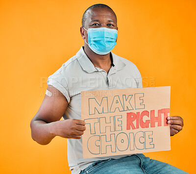Buy stock photo African american covid vaccinated man showing arm plaster, holding poster and wearing surgical face mask. Black model isolated on yellow studio background with copyspace. Corona vaccine promote sign