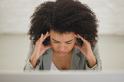 Buy stock photo Young mixed race businesswoman suffering from a headache while working on a desktop computer in an office at work. One stressed hispanic businessperson with a curly afro suffering from anxiety and looking upset from above