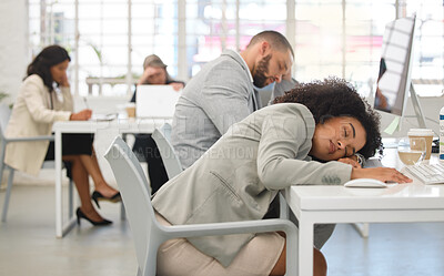 Buy stock photo Two young mixed race call center agents sleeping at their desks while working in an office at work. Hispanic customer service workers taking a nap while working together