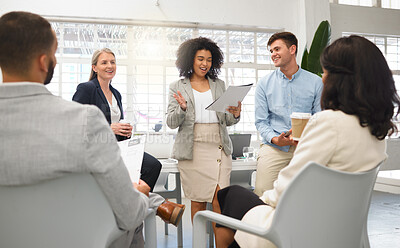 Buy stock photo Group of five diverse businesspeople having a meeting in an office at work. Happy mixed race businesswoman reading a report in a workshop. Business professionals planning together