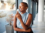 Young cheerful African american businesswoman removing her mask while at work. One happy black female businessperson taking off her mask protecting from virus while on a break at work