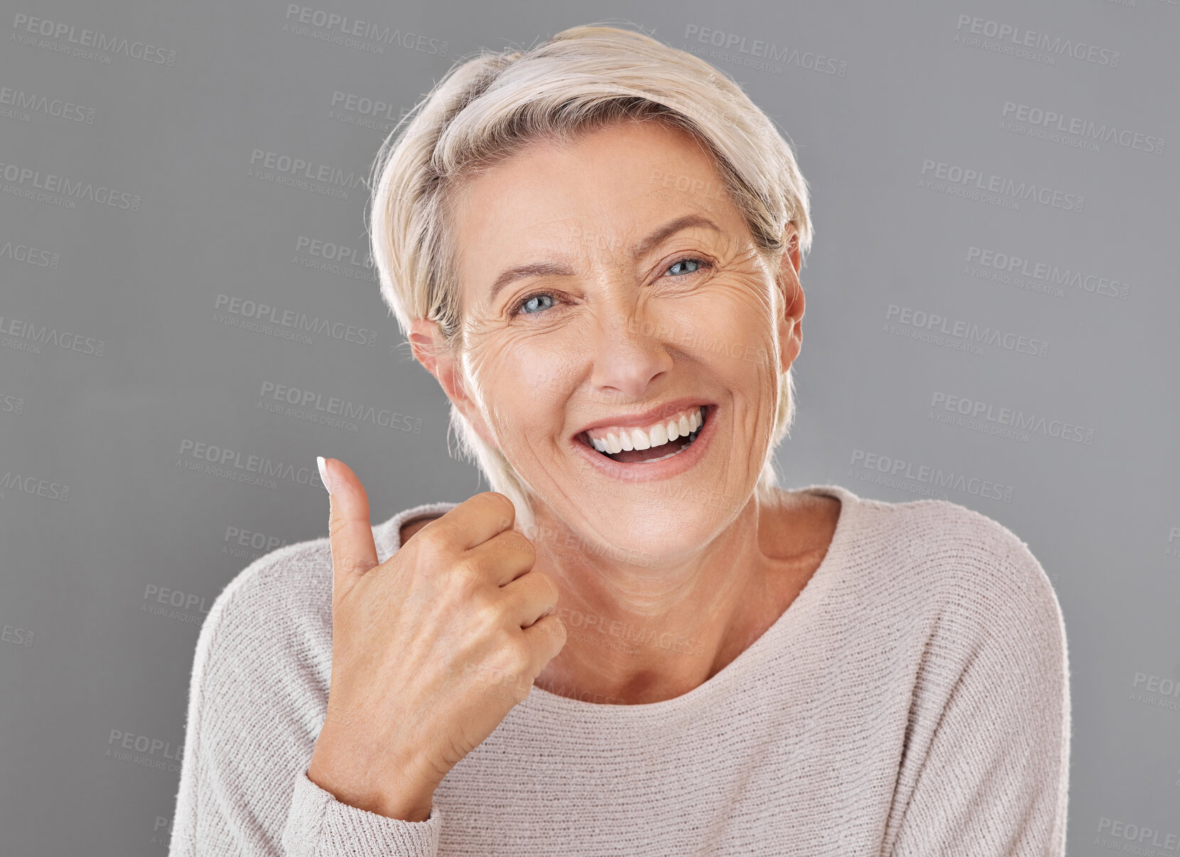 Buy stock photo Skincare, wellness and thumbs up by happy mature woman smiling showing winning hand gesture against studio background. Senior support and recommend cosmetic surgery, treatment or product for wrinkles