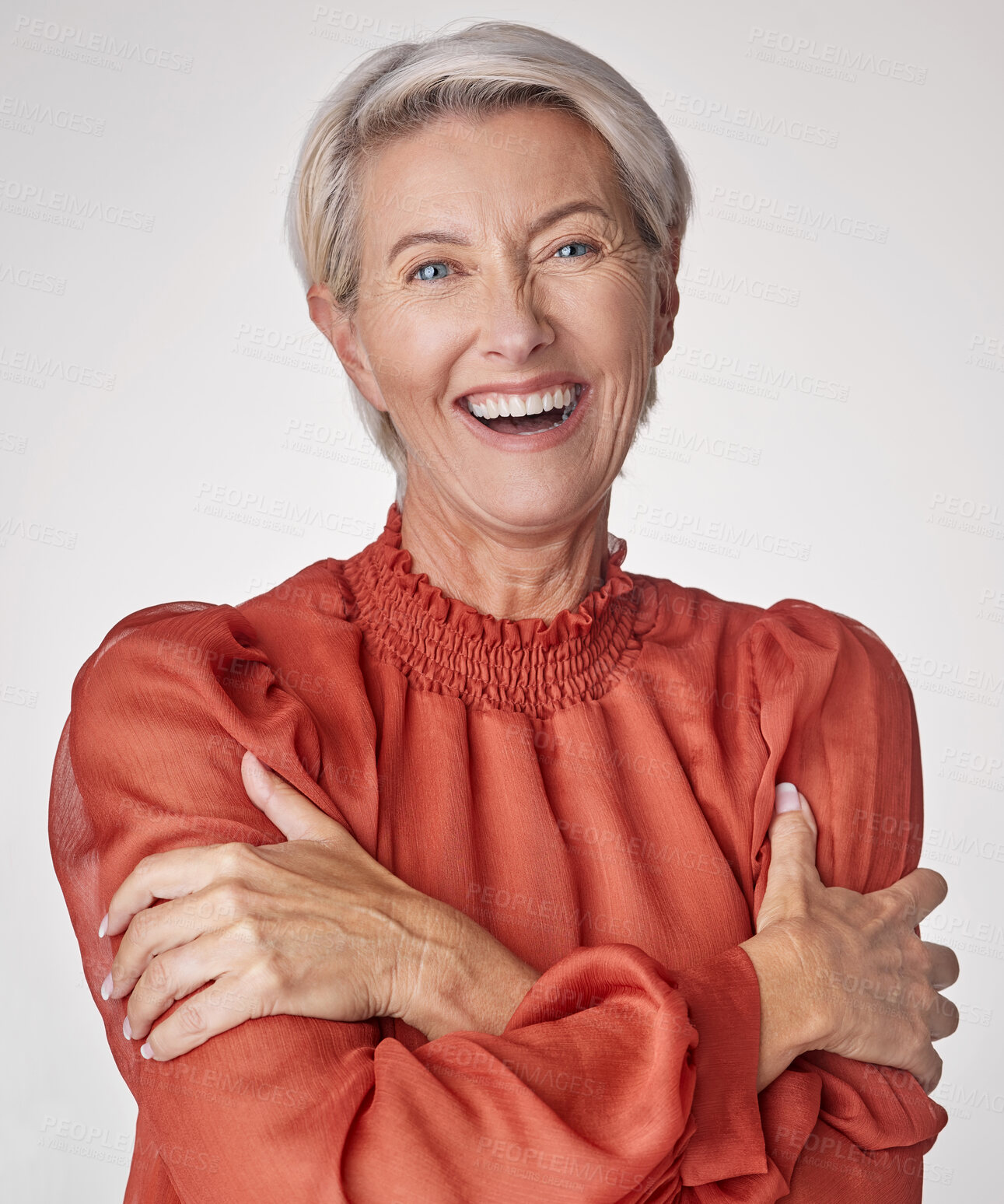 Buy stock photo Cheerful mature woman laughing and hugging herself against a grey studio background. Happy senior woman embracing and loving herself. Confident caucasian woman practicing self love