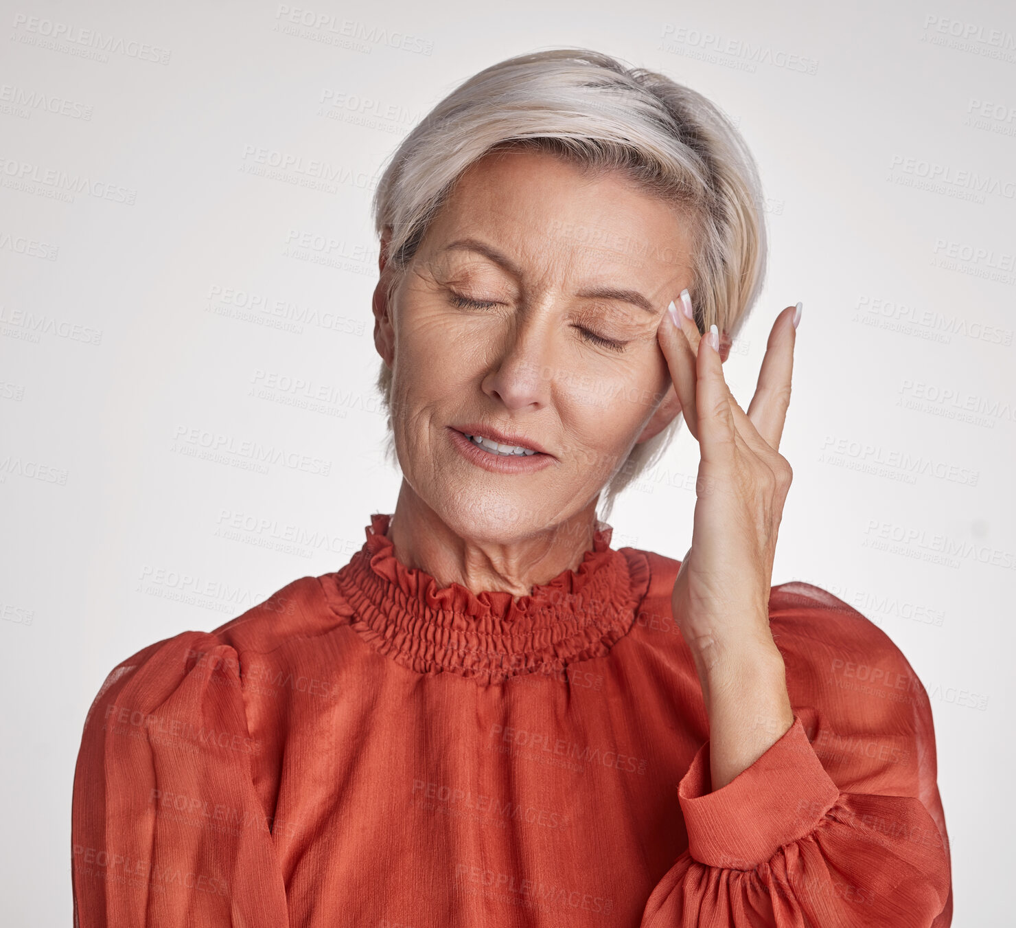 Buy stock photo One mature woman suffering with a headache and looking stressed while posing against a grey copyspace background. Ageing woman experiencing anxiety and fear in a studio