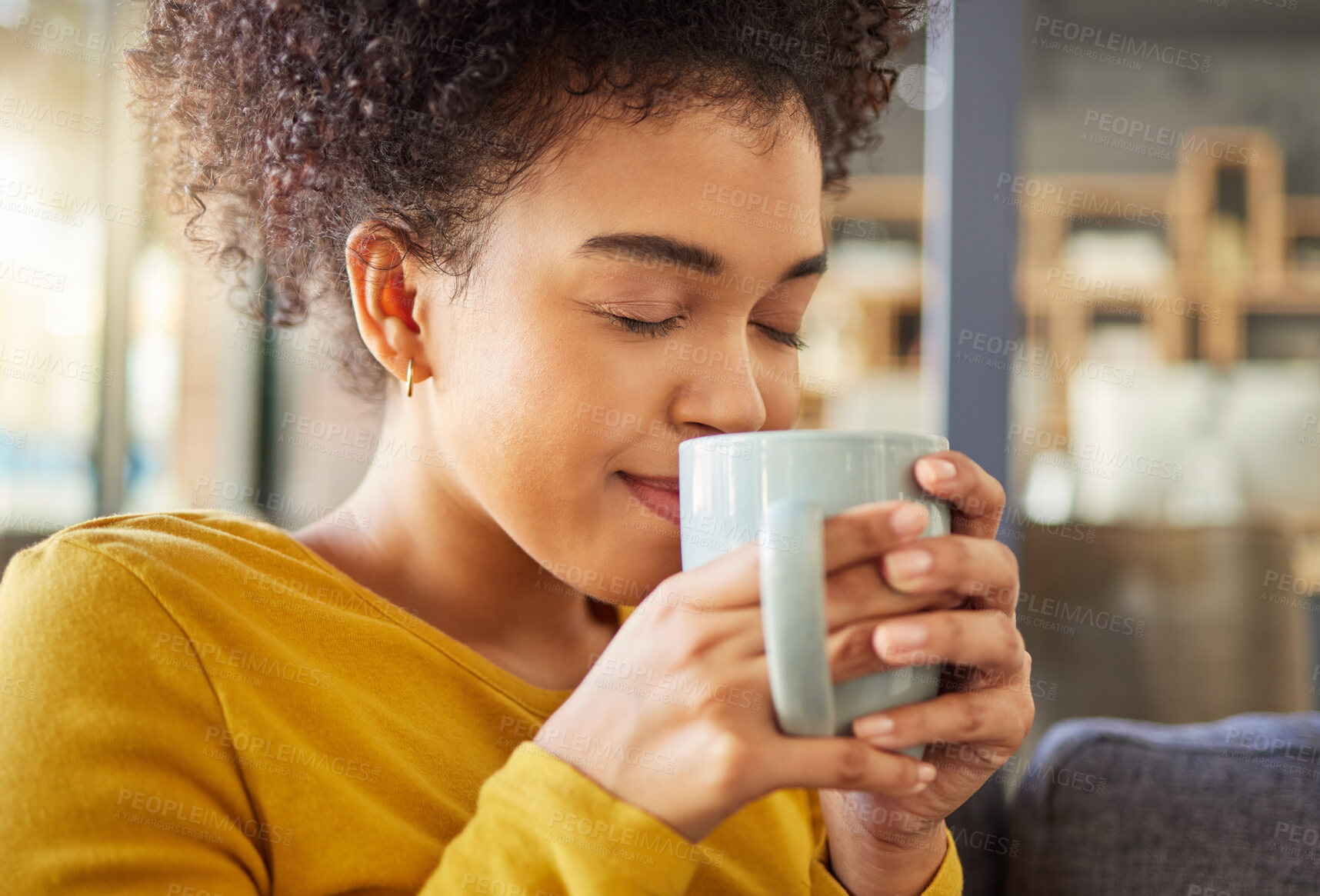 Buy stock photo African woman, coffee cup and smell on sofa, flavor and energy to start morning in apartment. Girl, happy and drink to relax with tea, matcha or espresso with fragrance, thinking and mug in house