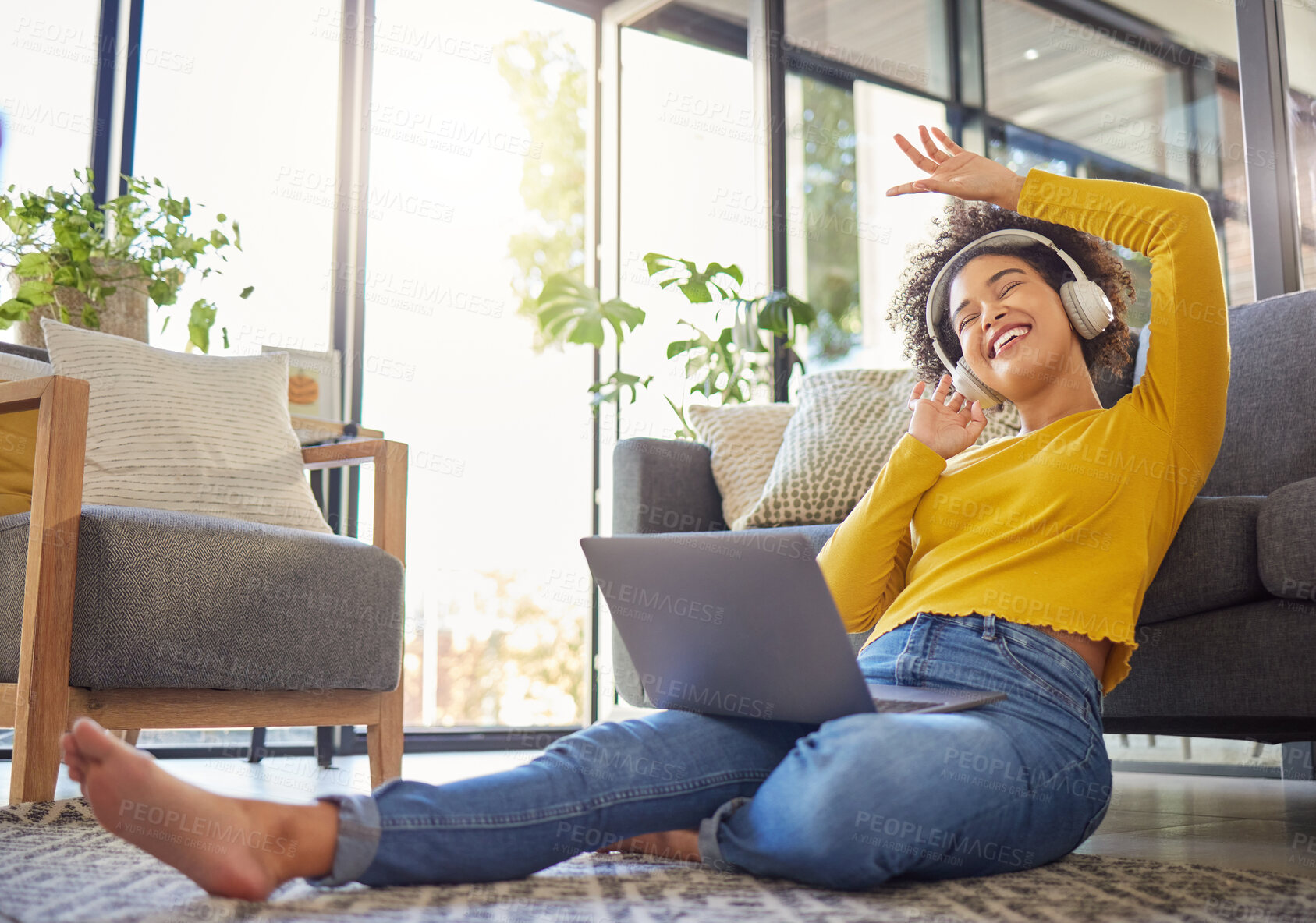 Buy stock photo Headphones, computer and home of woman dancing, singing and happy music, podcast streaming or audio. Floor, carpet and young african person on laptop, electronics and web listening in her living room