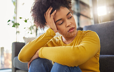 Buy stock photo African woman, sad and thinking on living room floor with worry, stress and memory of trauma in home. Gen z girl, anxiety and remember mistake, regret and mental health problem in lounge at apartment