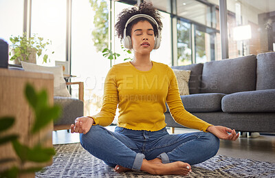 Buy stock photo Meditation, headphones and woman in home wellness, mental health or yoga podcast in living room. Music, streaming and african person meditate, holistic exercise and peace or lotus on audio technology
