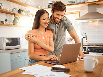 Buy stock photo Young happy interracial couple bonding while working on a laptop together at home. Caucasian boyfriend and girlfriend planning and using a laptop. Content wife and husband browsing online on a computer