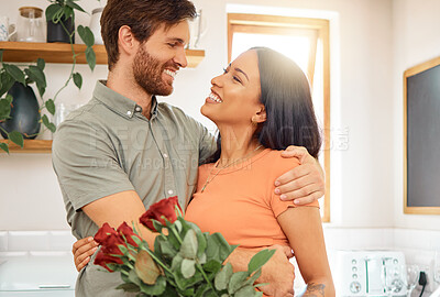 Buy stock photo Young caucasian boyfriend giving his mixed race girlfriend a bouquet of flowers at home. Hispanic wife receiving roses from her husband. Interracial couple bonding together at home