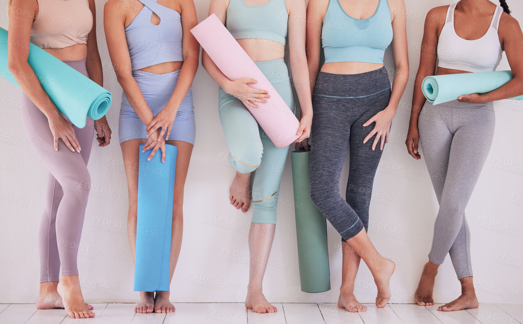 Buy stock photo Closeup of women ready for yoga class. Feet of group of women standing in yoga studio. Friends being social, talking before yoga class. Women in wellness yoga class with mats