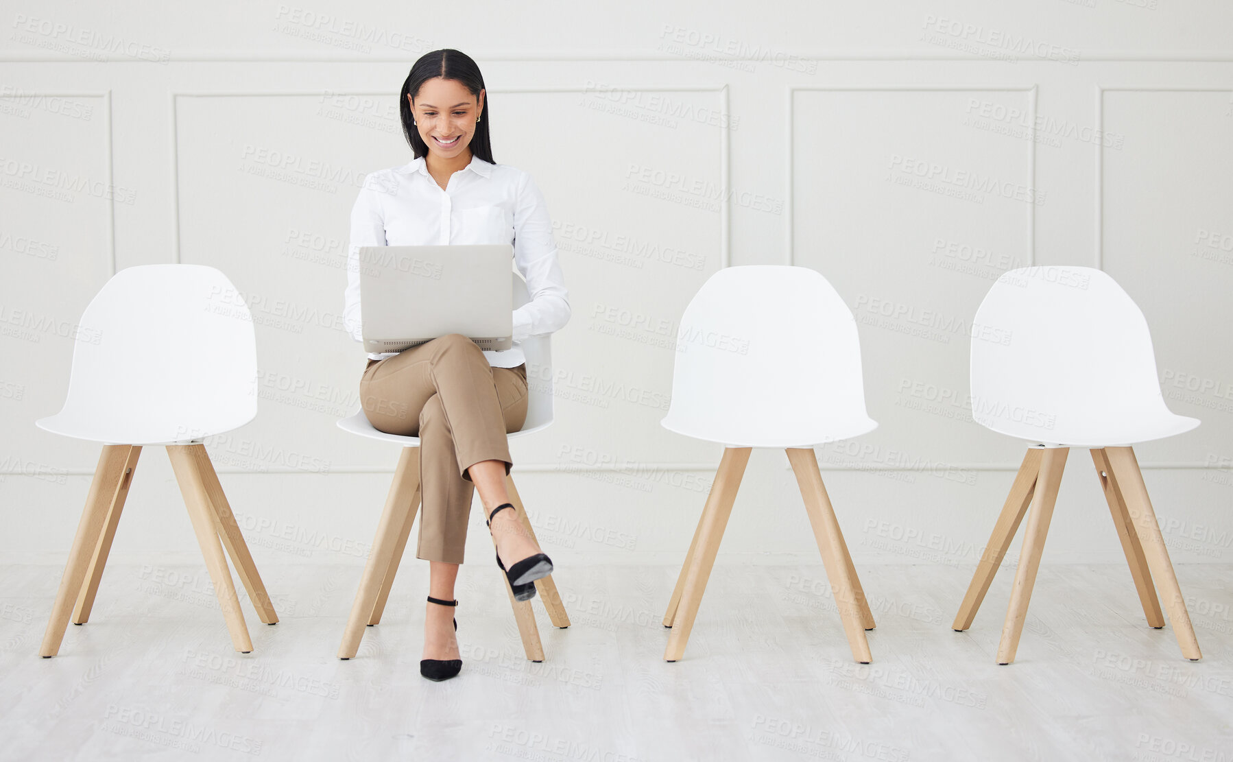 Buy stock photo Full length mixed race businesswoman waiting for interview and using laptop. Applicant sitting alone, browsing internet on technology. Candidate in line for job opening, vacancy, office opportunity