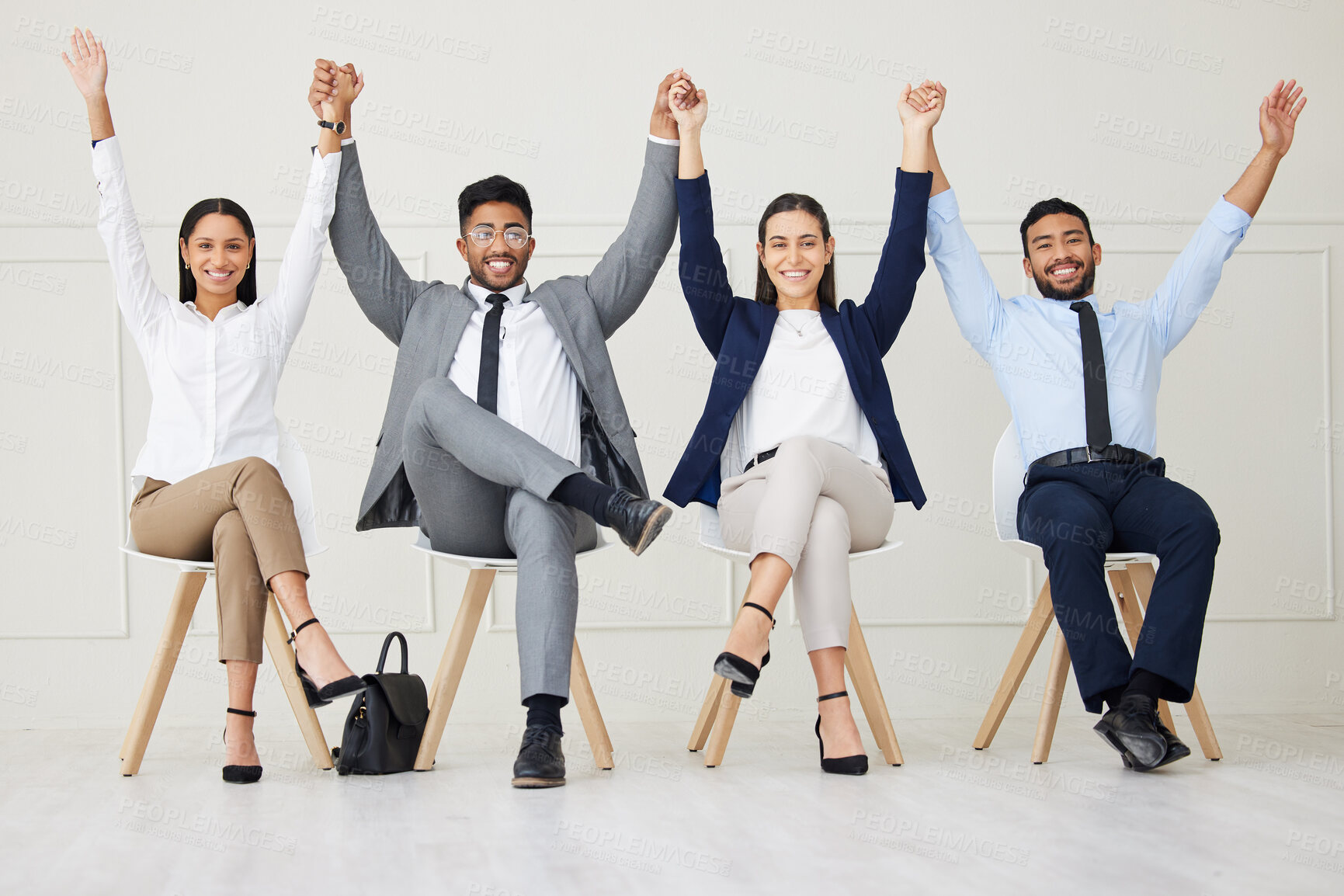 Buy stock photo Group of diverse businesspeople celebrating success after interview. Team of applicants together, holding hands with arms raised. Candidates in line for job opening, vacancy and office opportunity