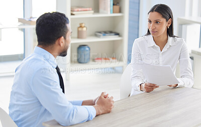 Mixed race hiring manger in interview with businessman. CEO with resume and cv of candidate looking for job opening, vacancy, office opportunity. Applicant sitting and explaining experience to hr boss