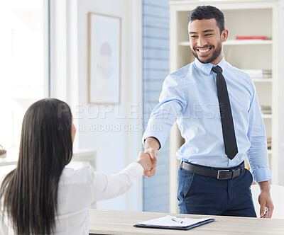 Two mixed race businesspeople in handshake after signing contract in interview. Asian applicant meeting CEO and hiring manger. Candidate hired for job opening, vacancy, office opportunity, promotion