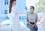 Doctor using thermometer to check the temperature of a patient. Physician using a thermometer to scan the temperature of a patient. healthcare worker wearing a mask in consult with a patient