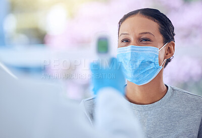 Buy stock photo Doctor holding a temperature thermometer. Physician using a monitor to scan a patients temperature. Essential worker using equipment to check a patients temperature. Patient in consult for covid