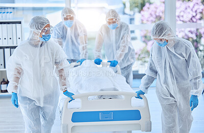 Buy stock photo Biohazard team moving a dead body in a hospital bed. Team of doctors collecting a body dead from covid. Scientists in hazmat suits working in disease disaster area. Medical staff moving hospital bed