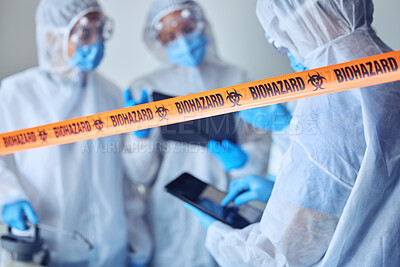 Buy stock photo Closeup of biohazard tape blocking of prohibited area. Team of scientists cleaning prohibited area. Medical csi team using a digital tablet in quarantine area. Biologist using wireless device