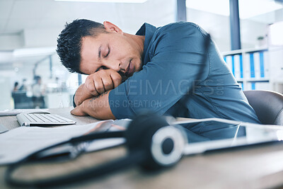 Buy stock photo One hispanic call centre telemarketing agent sleeping in an office. Businessman feeling overworked, tired and demotivated while operating helpdesk. Lazy consultant slacking and ignoring customers by taking a nap. Burnout and stress in the workplace