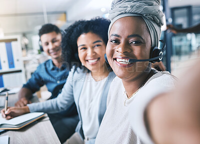 Portrait of happy african american call centre telemarketing agent taking selfies with diverse colleagues in an office. Confident and ambitious consultants determined to provide the best customer service and sales support