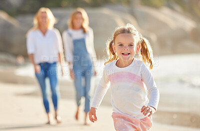 Buy stock photo Portrait of an adorable little girl running and smiling on the beach during summer. Cute little girl having fun outdoors with the family