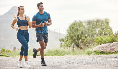 Fit young man and woman running together outdoors. Interracial couple and motivated athletes doing cardio workout while exercising for better health and fitness at the park