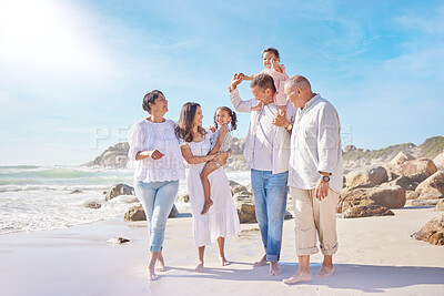 Buy stock photo A smiling mixed race three generation family with little girls walking together on a beach. Adorable little kids bonding with mother, father, grandmother and grandfather outside