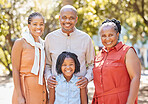 Portrait happy african american family of four spending quality time together in the park during summer. Grandparents, mother and daughter bonding together outside. An outing with the granddaughter