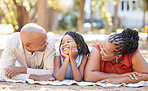 Happy african american family of three spending quality time together in the park during summer. Grandparents and granddaughter bonding together outside. Granny and grandpa out with their grandchild