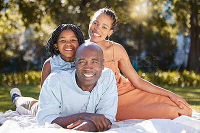 Buy stock photo Portrait happy african american family of three spending quality time together in the park during summer. Mother, father and daughter bonding together outside. A cute girl and parents smiling outdoors