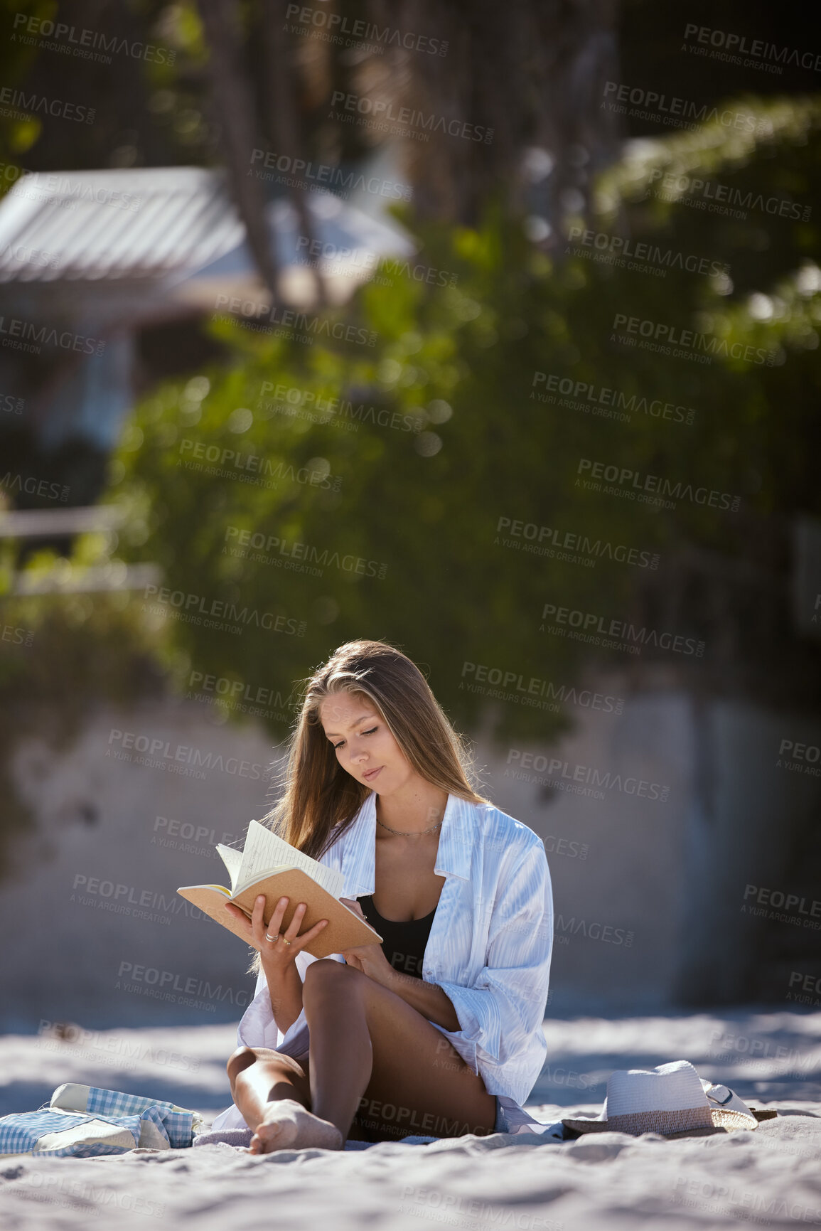 Buy stock photo Woman on the beach, reading book and travel, relax in nature in summer holiday with peace and calm. Young female person is outdoor with novel to read, seaside vacation and relaxation in the sun