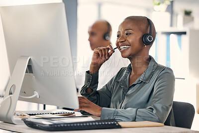 Buy stock photo Happy young african american call centre telemarketing agent talking on a headset while working on a computer in an office. Confident friendly female consultant operating helpdesk for customer service and sales support