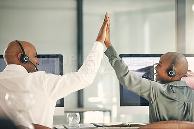 Buy stock photo Two happy call centre telemarketing agents from the back giving each other high five and cheering with joy while working in an office. Excited and ambitious consultants celebrating successful sales targets and winning victory