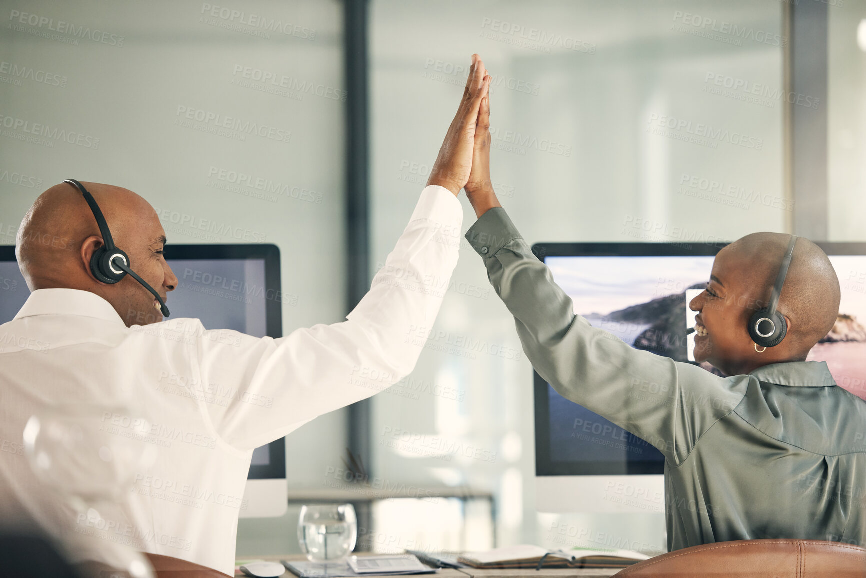 Buy stock photo Customer service, team and high five for success with headset at computer for sales or telemarketing. Back of black man and woman celebrate bonus, crm solution or target achievement in a call center