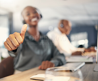 Buy stock photo Closeup of african american call centre telemarketing agent gesturing thumbs up for approval and success in an office. Hands of happy female consultant determined to give good customer service and best sales support