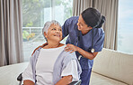 A hispanic senior woman in a wheelchair and her female nurse in the old age home. Mixed race young nurse and her patient in the lounge