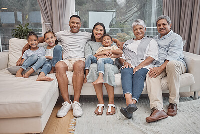Buy stock photo Happy and affectionate young mixed race family of seven sitting on a sofa in the home living room. Married couple with their mother, father, son and daughter in the lounge. Granny and grandpa visit