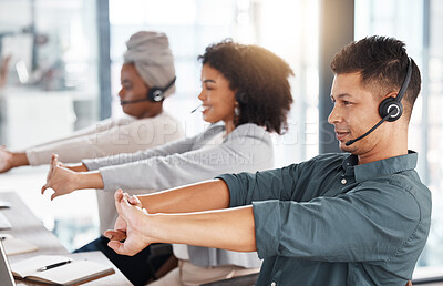 Buy stock photo Call center, headset and team stretching at desk while tired or to start telemarketing work. Diversity women and a man together at a desk to exercise for crm, customer service and help desk support