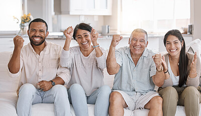 Buy stock photo Mixed race family celebrating sitting on the sofa in the lounge at home. Hispanic family looking ecstatic in the living room