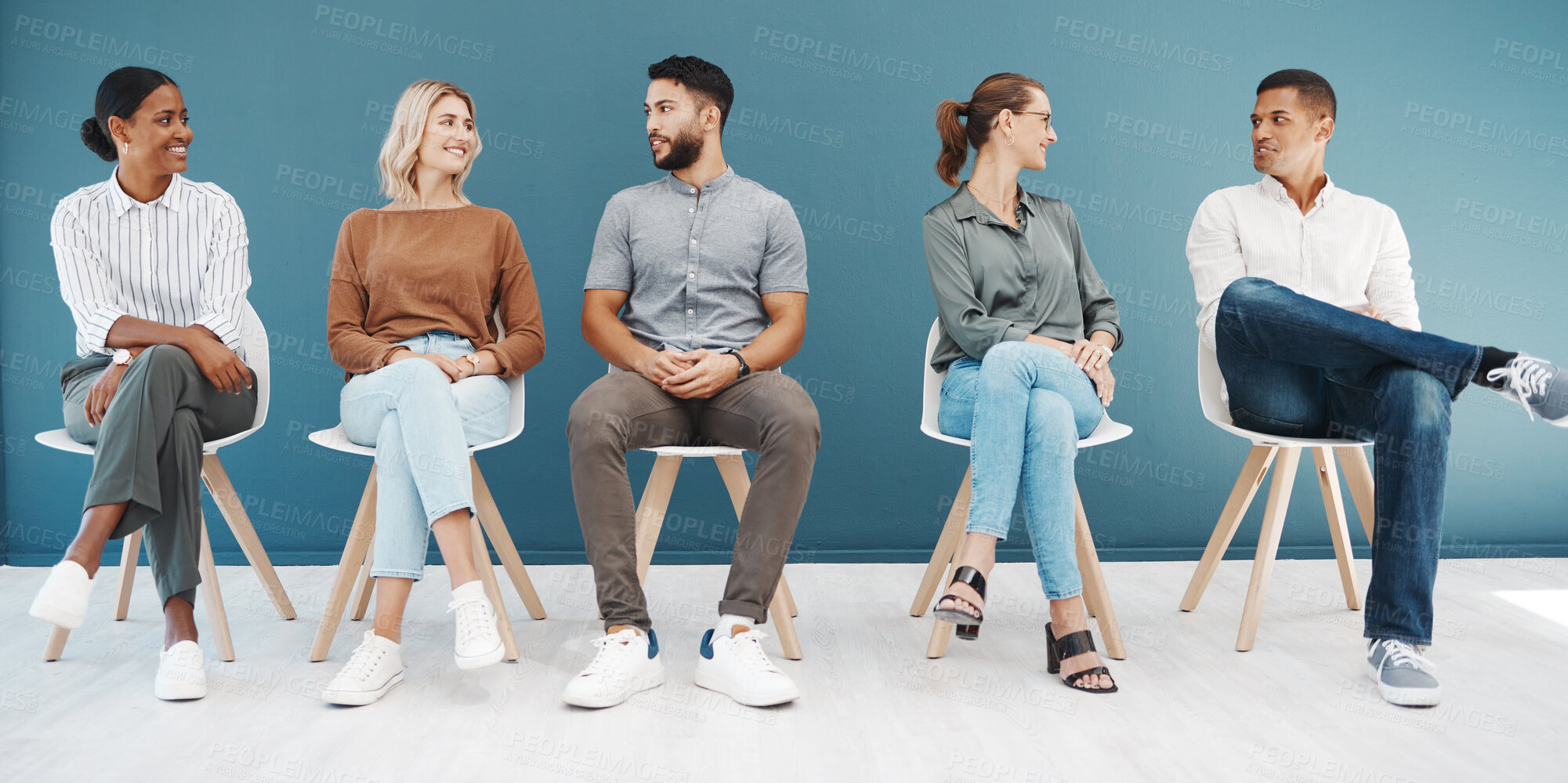 Buy stock photo Interview queue, business people and talk by wall with smile, diversity and waiting room for hr recruitment. Men, women and happy together for interview, human resources and hiring for job at startup