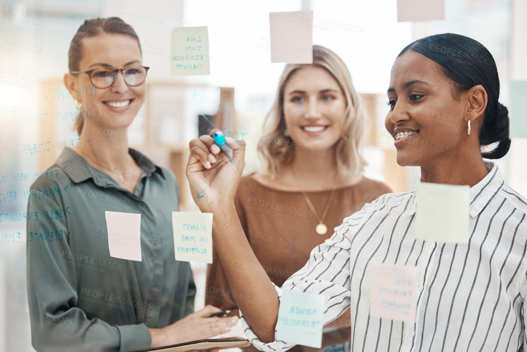 Buy stock photo Meeting, planning and a business woman writing on glass with her team for strategy or brainstorming in an office. Collaboration, coaching and leadership with a female employee teaching her colleagues